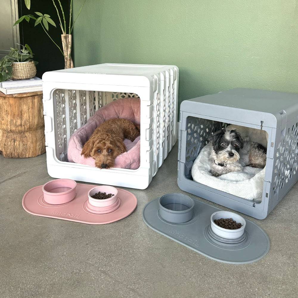 pink and grey Portable & Travel Dog Bowl & Pet Bowl with silicone mat and bowls white and grey crate behind with two dogs 